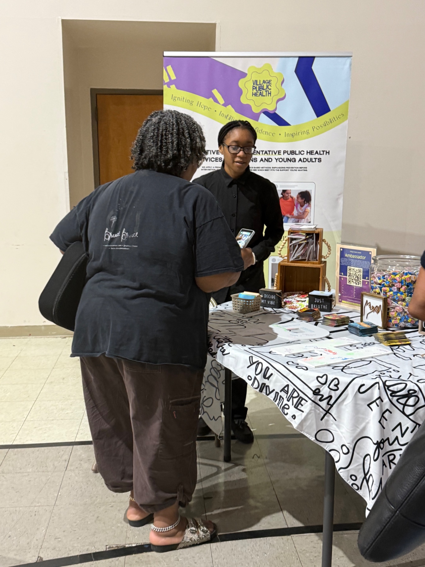 Village Public Health table with wellness materials at a community event