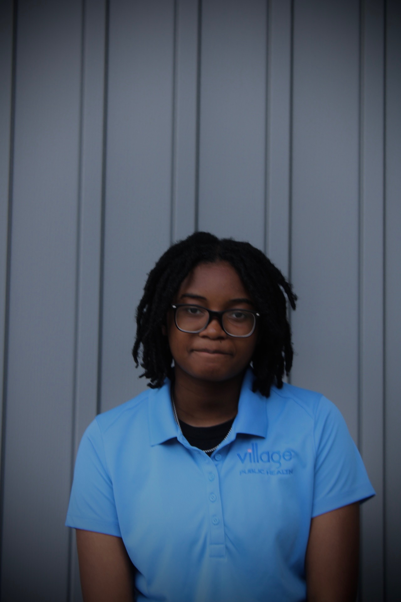 Summer Institute student portrait in a Village Public Health polo