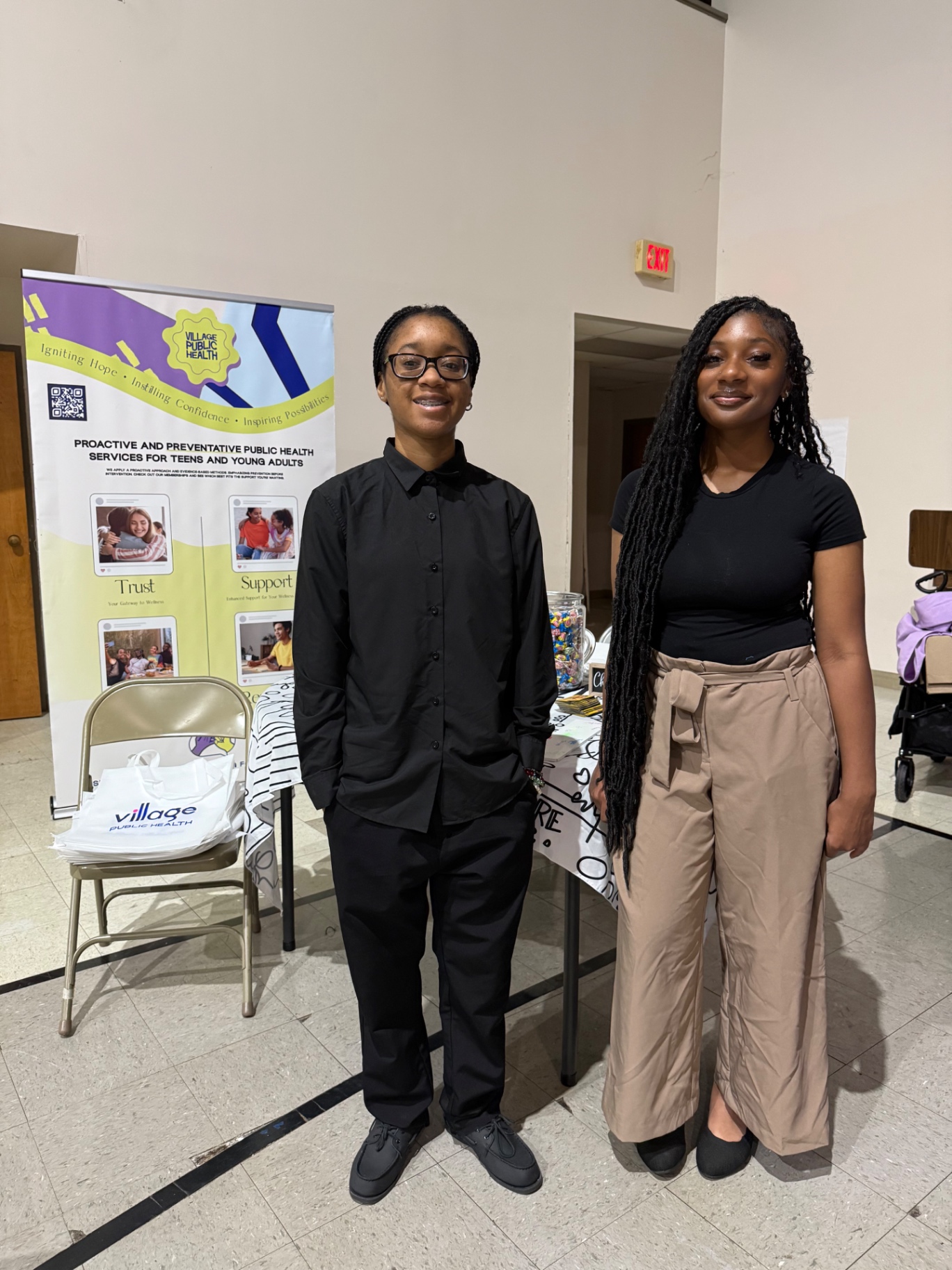 Two team members hosting the Village Public Health table