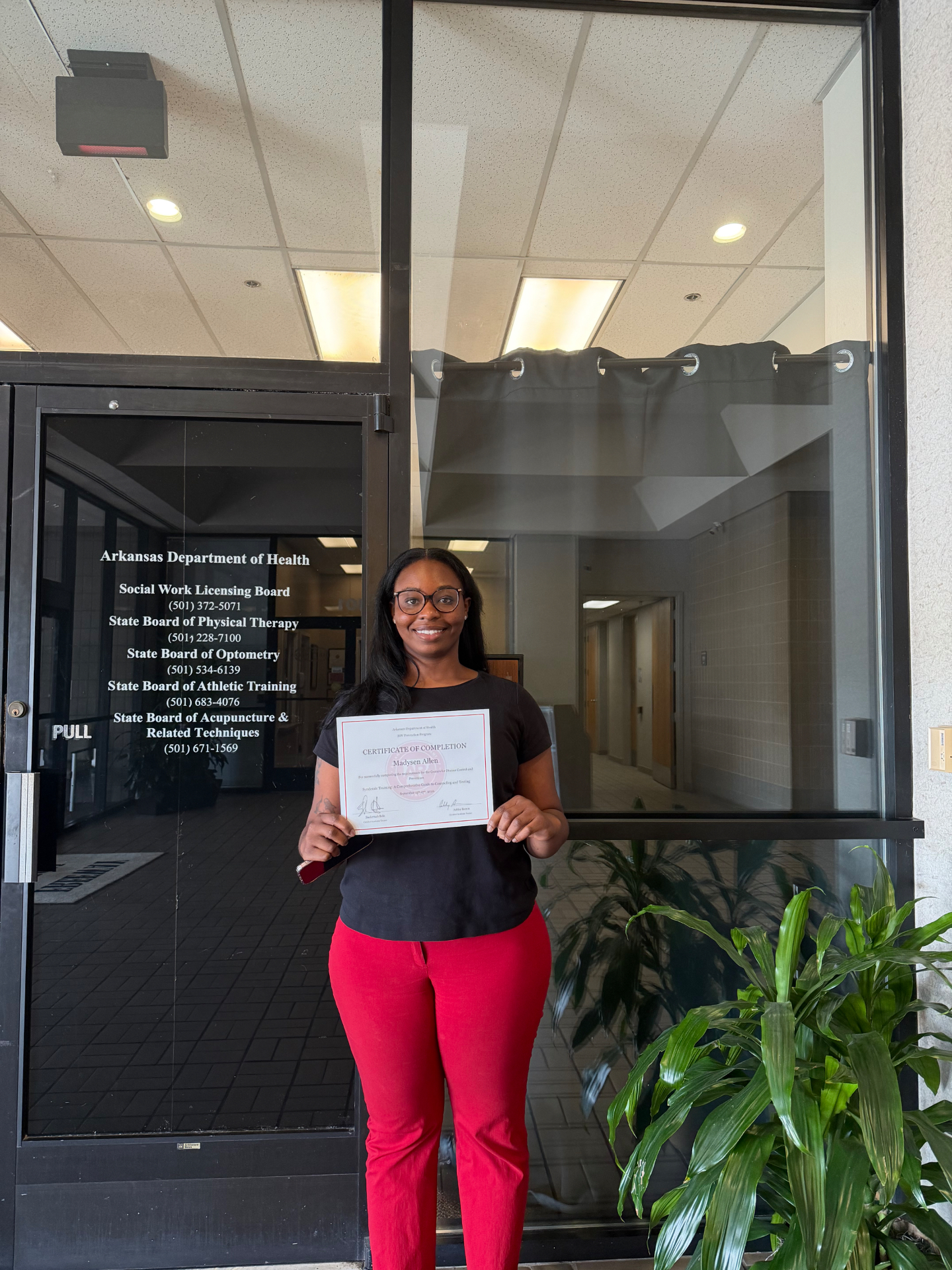 Madysen Allen holding her Arkansas Department of Health syndemic training certificate of completion