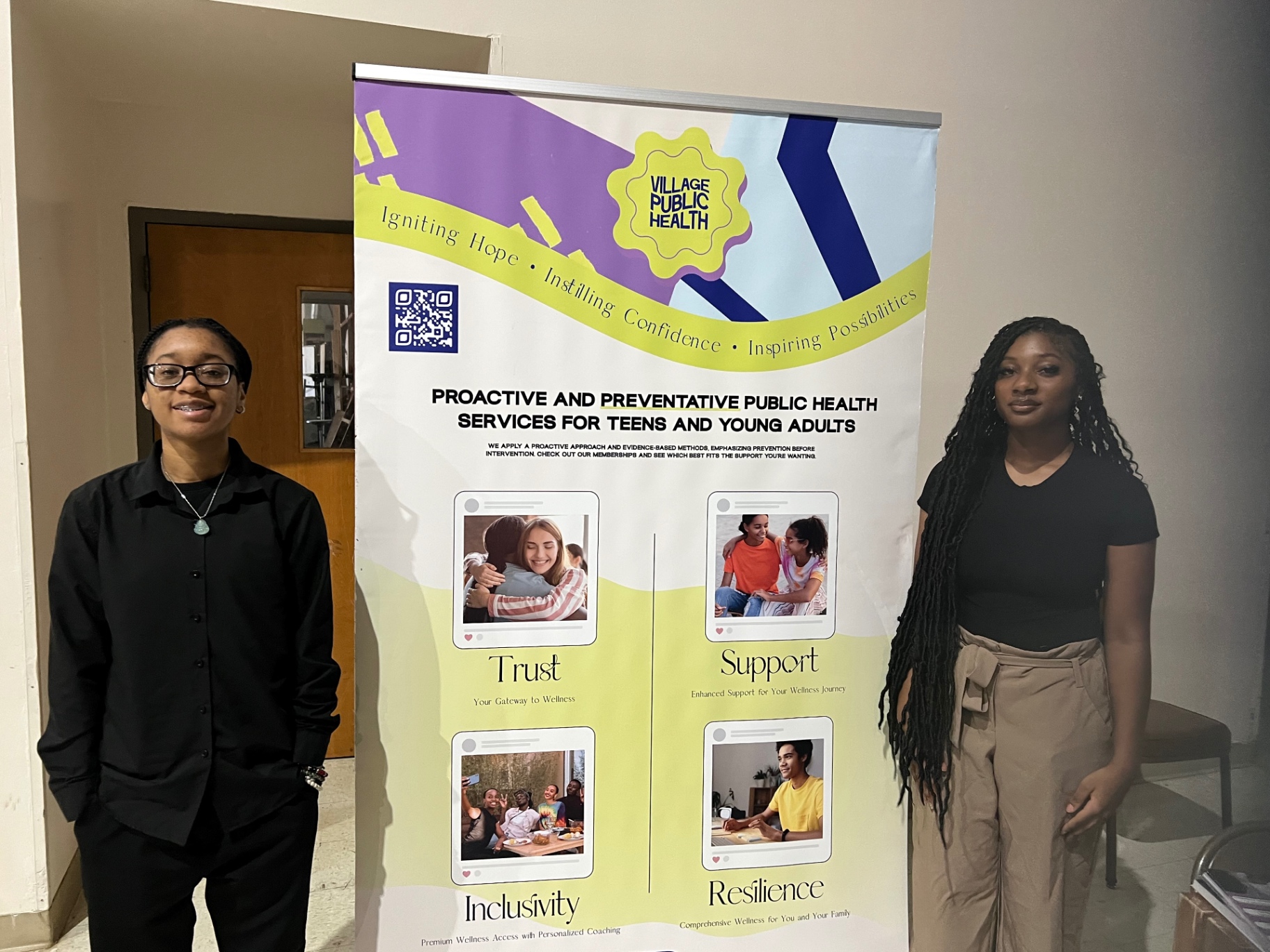 Team members beside the Village Public Health banner
