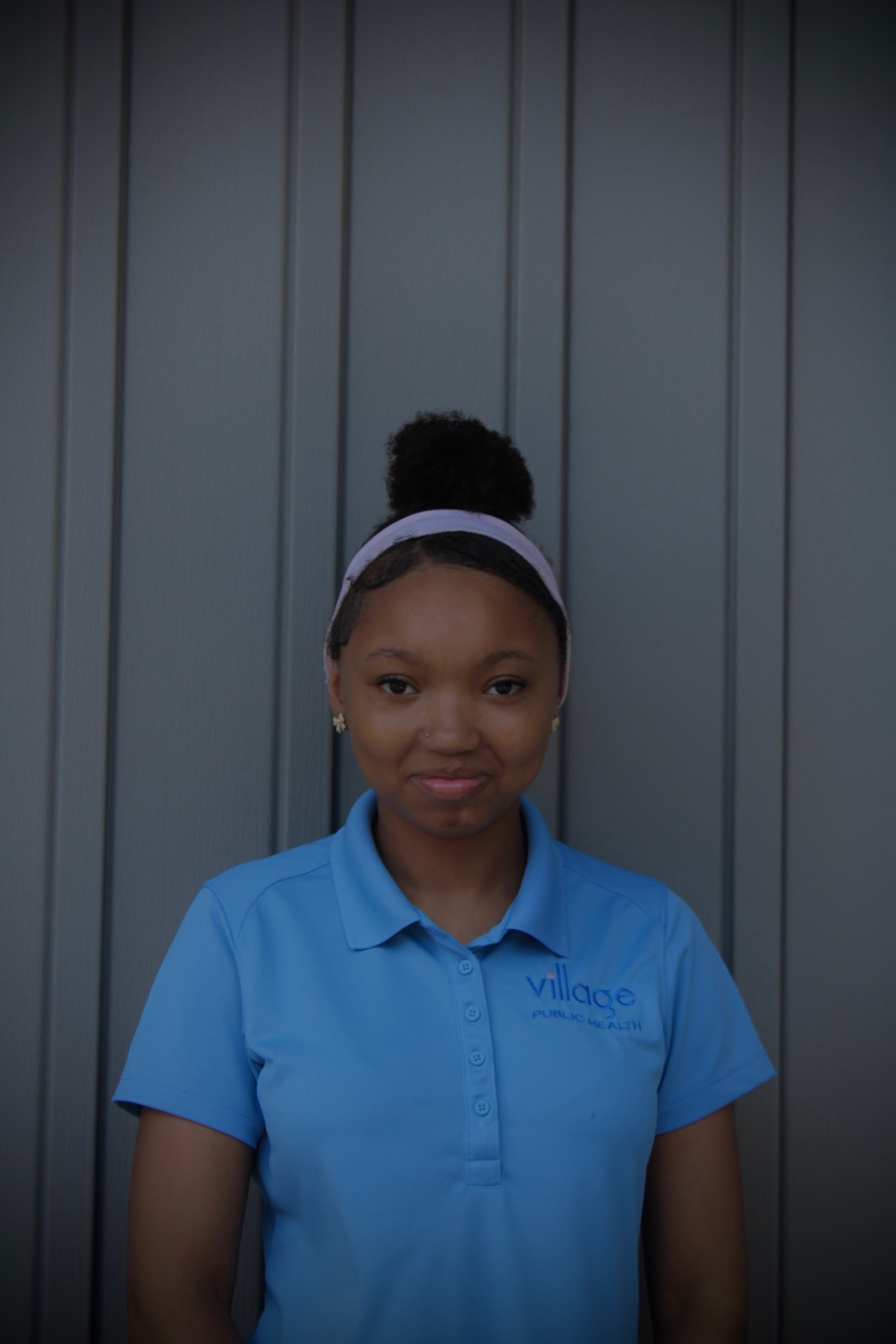 Summer Institute student portrait in a Village Public Health polo