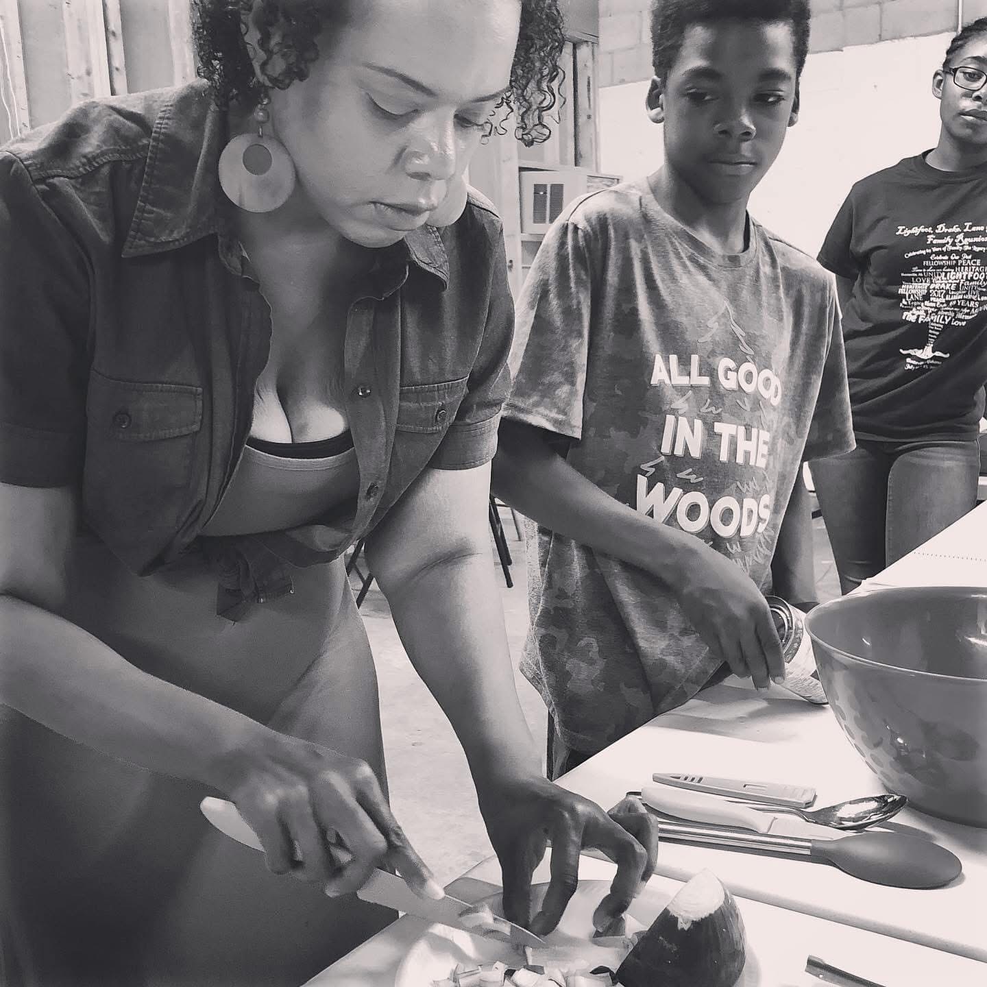 Dr. Mumford leading a hands-on cooking workshop with youth