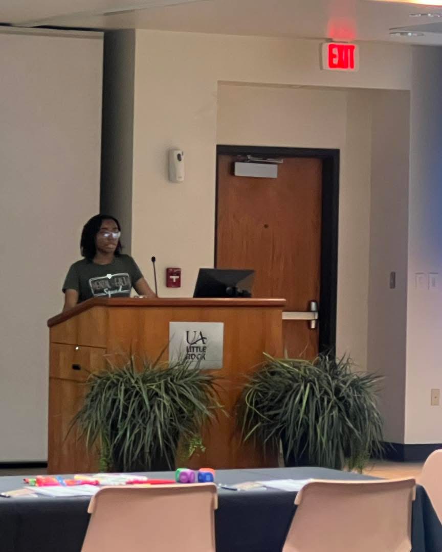 Student presenting at UA Little Rock podium
