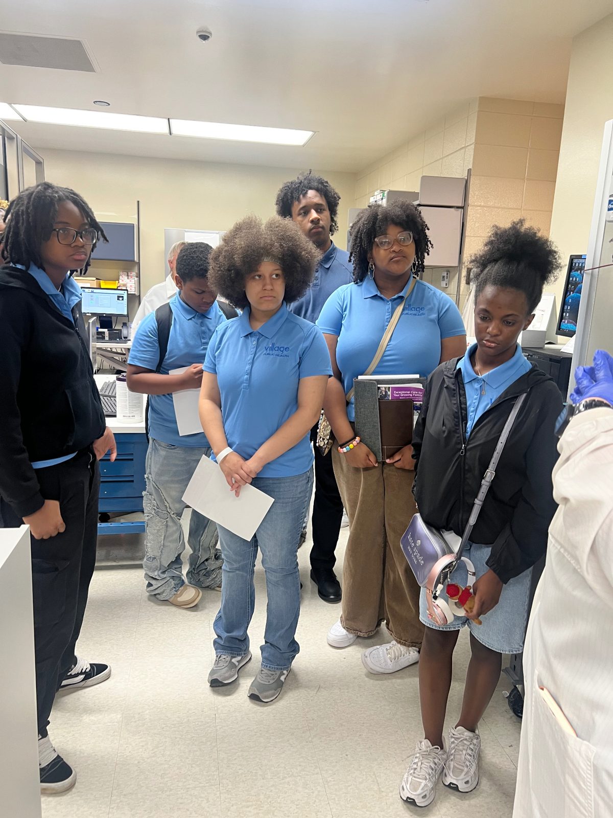 Summer Institute students touring a hospital lab with a clinician