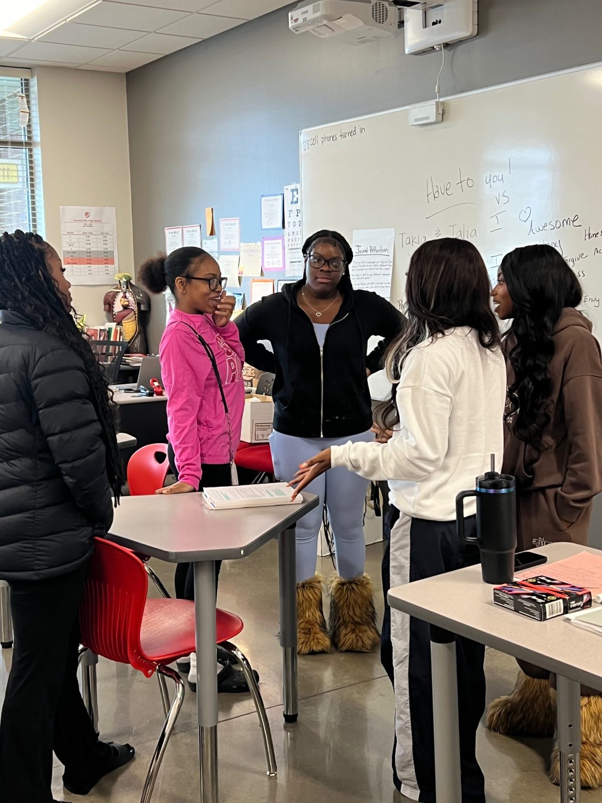 W.E.L.L. Squad members talking in a small group around a table